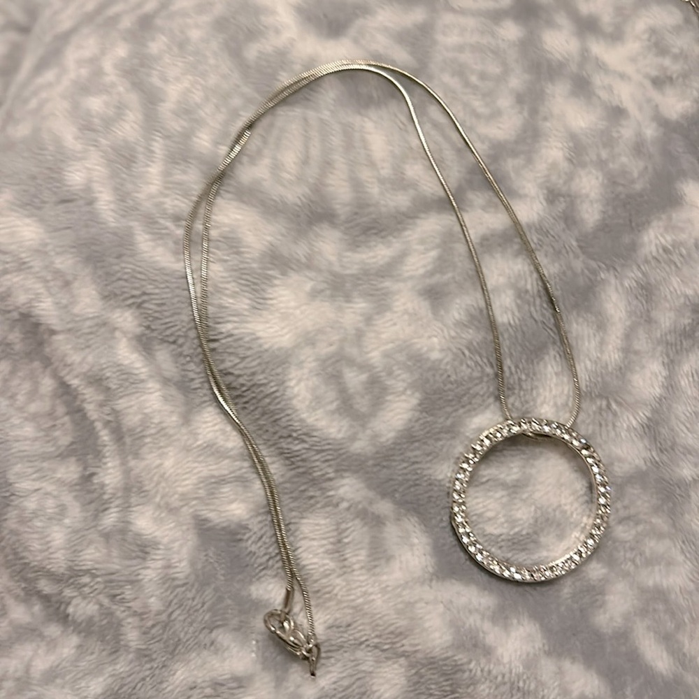 Silver diamond necklace missing one dimond.